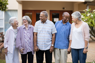 group of seniors standing and smiling at each other
